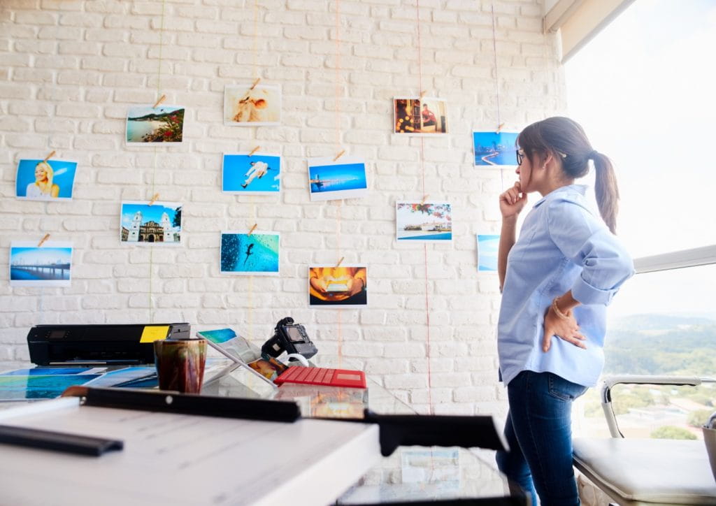 woman looking at photos on a wall