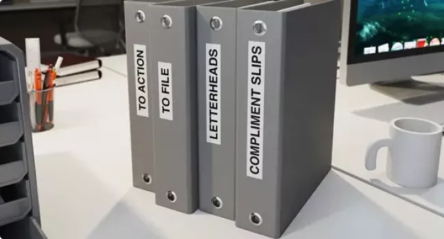 Four file folders with Brother P-touch labels on spine identifying the contents of the folders