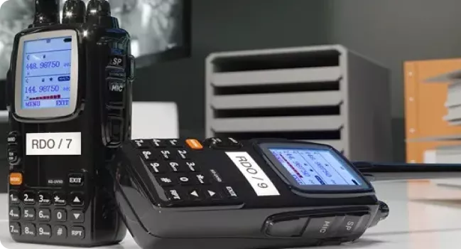 Two radio walkie-talkies with identification labels produced on a Brother P-touch label printer